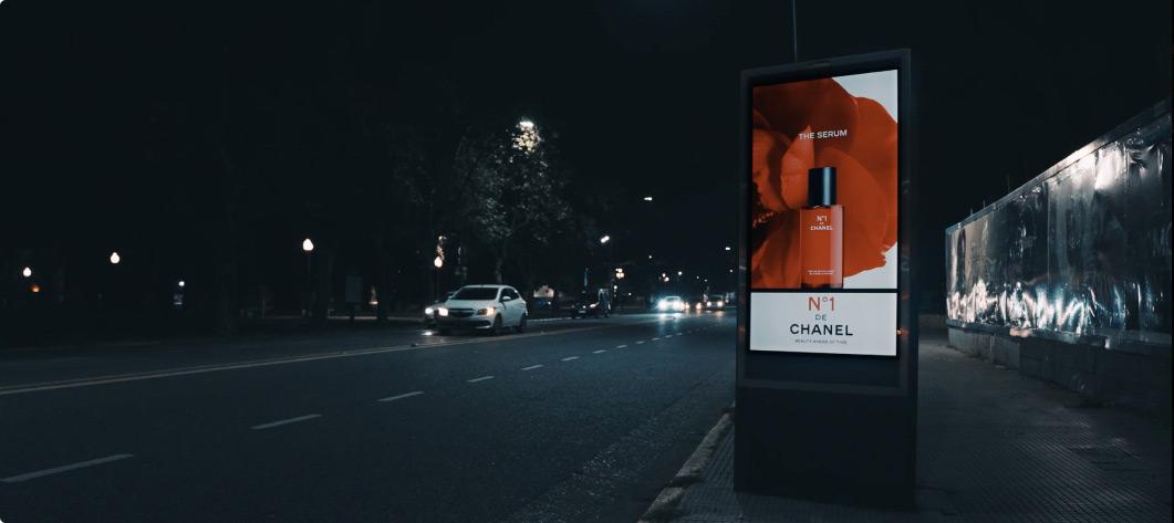 Screen with Chanel advertising on a busy street