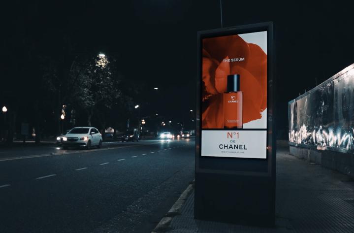 Screen with Chanel advertising on a busy street