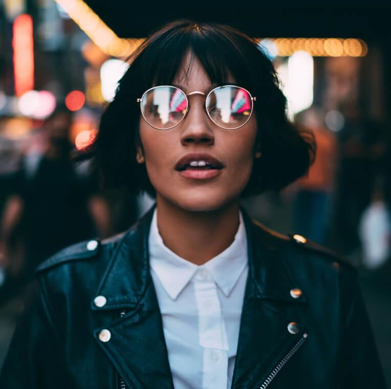 A woman with glasses looking straight ahead